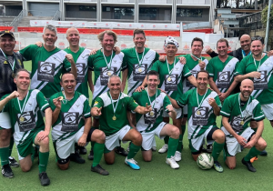 Adult male soccer team wearing green and white uniforms